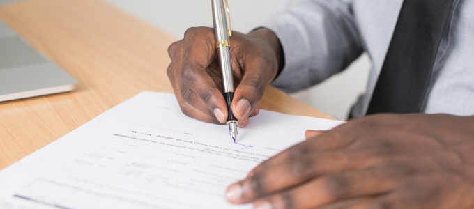 Man signing a form